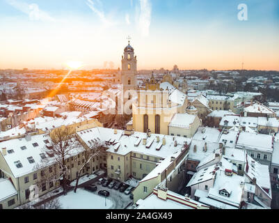 Beautiful Vilnius city panorama in winter with snow covered houses, chruches and streets. Aerial evening view. Winter city scenery in Vilnius, Lithuan Stock Photo