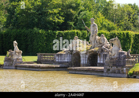 A statue of Neptune and wild horses at the 14th-century Chateau de Beloeil, residence of the Prince de Ligne, in Beloeil (Hainaut), Belgium Stock Photo