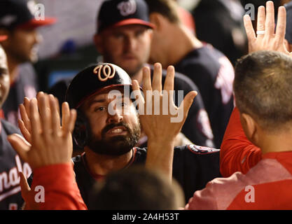 Washington, United States. 14th Oct, 2019. Washington Nationals' Adam Eaton is greeted by teammates after scoring against the St. Louis Cardinals on an RBI double by Anthony Rendon during the third inning of game 3 in the NLCS at Nationals Park in Washington, DC, on Monday, October 14, 2019. Photo by Kevin Dietsch/UPI Credit: UPI/Alamy Live News Stock Photo