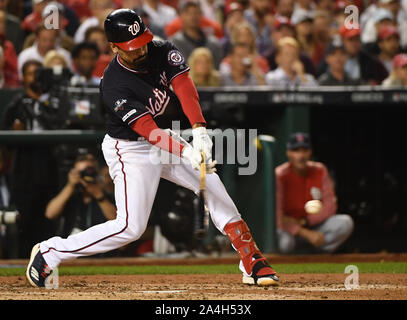 Washington, United States. 14th Oct, 2019. Washington Nationals' Anthony Rendon hits an RBI double against the St. Louis Cardinals to score Adam Eaton during the third inning of game 3 in the NLCS at Nationals Park in Washington, DC, on Monday, October 14, 2019. Photo by Kevin Dietsch/UPI Credit: UPI/Alamy Live News Stock Photo