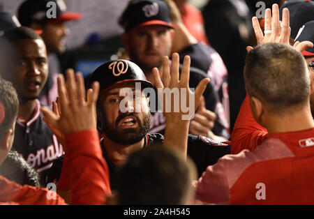 Washington, United States. 14th Oct, 2019. Washington Nationals' Adam Eaton is greeted by teammates after scoring against the St. Louis Cardinals on an RBI double by Anthony Rendon during the third inning of game 3 in the NLCS at Nationals Park in Washington, DC, on Monday, October 14, 2019. Photo by Kevin Dietsch/UPI Credit: UPI/Alamy Live News Stock Photo