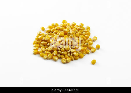 a group of dried corn kernels on white background Stock Photo