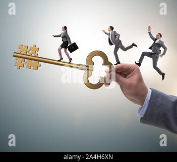 The business people chasing each other towards key to success Stock Photo