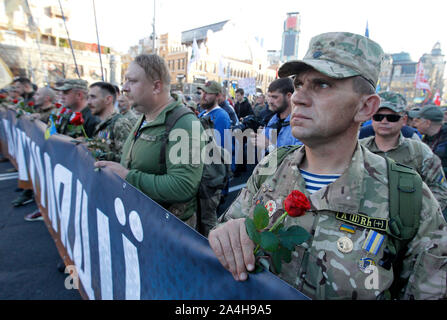 Kiev, Ukraine. 14th Oct, 2019. Ukrainian veteran holds a flower during the march commemorating the 77th anniversary of the founding of the UPA.The Ukrainian Insurgent Army (UPA) active fought for Ukrainian independence from 1942 to 1949, mostly in Western Ukraine against the German Nazi and Soviet regimes. Ukrainians also mark the Defender of Ukraine Day on the same date. Credit: SOPA Images Limited/Alamy Live News Stock Photo