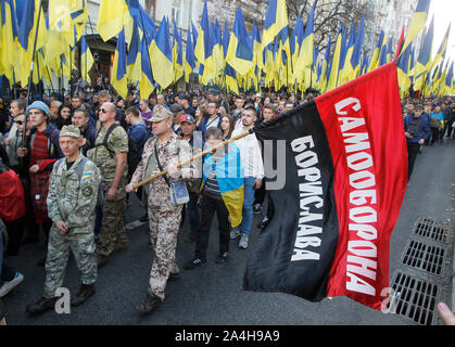 Kiev, Ukraine. 14th Oct, 2019. Ukrainian far-right activists with flags during the march commemorating the 77th anniversary of the founding of the UPA.The Ukrainian Insurgent Army (UPA) active fought for Ukrainian independence from 1942 to 1949, mostly in Western Ukraine against the German Nazi and Soviet regimes. Ukrainians also mark the Defender of Ukraine Day on the same date. Credit: SOPA Images Limited/Alamy Live News Stock Photo