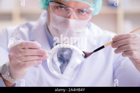 The forensics investigator working in lab on crime evidence Stock Photo