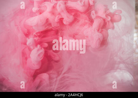 Pink smoke colorful abstract background, Liquid dynamic paint splash in water, pink acrylic ink mixing in water Stock Photo
