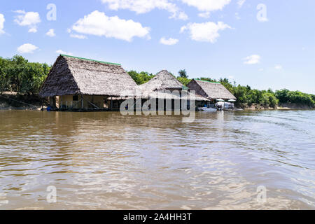 Floating houses neighborhood on the river in Iquitos - Peru Stock Photo