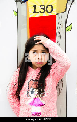 Little girl is measuring growth on the background of the wall. Growth concept Stock Photo