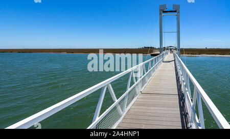 Pedestrian bridge connecting Pedra del Rei with Ilha de Tavira and Barril beach, Algarve, Portugal Stock Photo