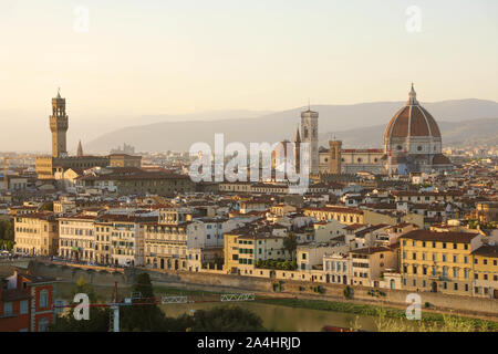 Florence city during golden sunset. Panoramic view of the river Arno with Palazzo Vecchio palace and Cathedral of Santa Maria del Fiore (Duomo), Flore Stock Photo