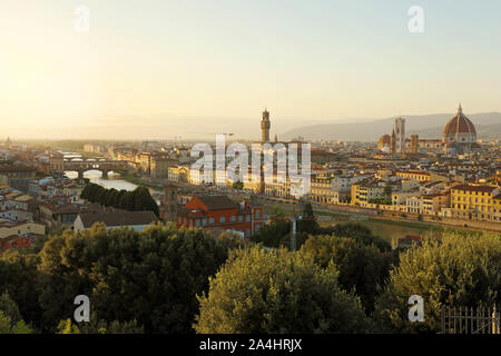 Florence city during golden sunset. Panoramic view of the river Arno with Ponte Vecchio bridge, Palazzo Vecchio palace and Cathedral of Santa Maria de Stock Photo