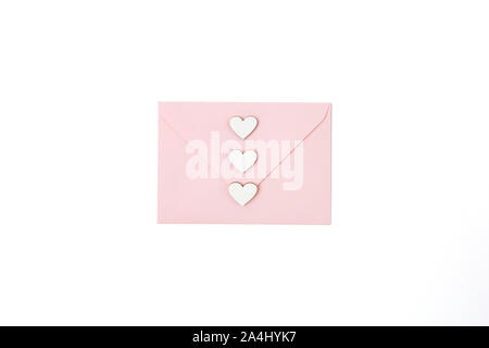 Envelope with wooden hearts on white background Stock Photo