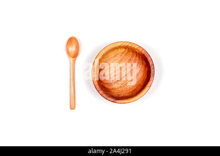 Top view of handmade empty wooden bowl with wooden spoon isolated on white background. Stock Photo