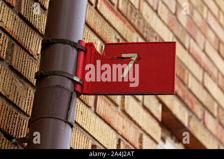 the seven digit with white text on red background as signboard mounted on a lamppost Stock Photo