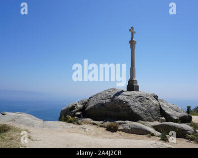 Stone cross at Cape Finisterre. Symbol of pilgrims on Cape Finisterre in a Galicia Spain. Stock Photo