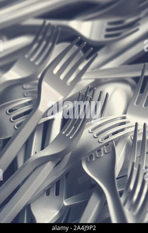 Plastic forks scattered on wooden table, top view Stock Photo