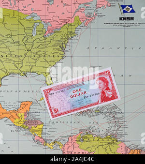 papenburg, germany - 2019.10.14: one dollar banknote of the east caribbean currency authority on a historic map of dutch knsm shipping company Stock Photo