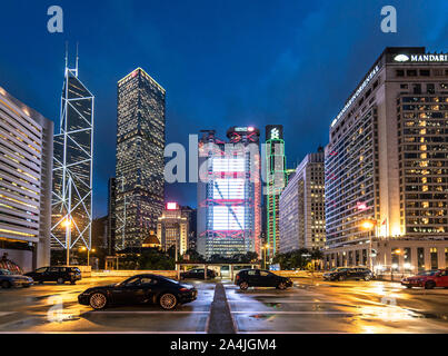 Hong Kong - China - July 4 2019: Luxury sport cars parked on a rooftop parking in Hong Kong Central business district with major bank office building Stock Photo