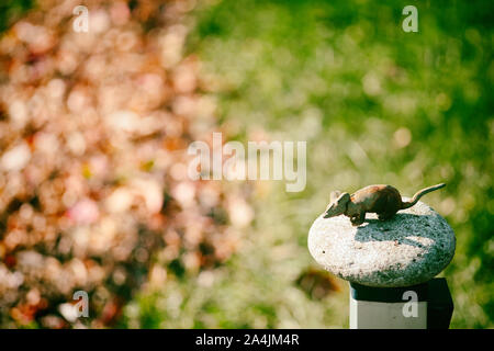 Little toy mouse in the autumn landscape. Country house decor Stock Photo
