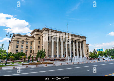 Almaty Kazakh-British Technical University Side View with Walking Pedestrians on a Sunny Blue Sky Day Stock Photo