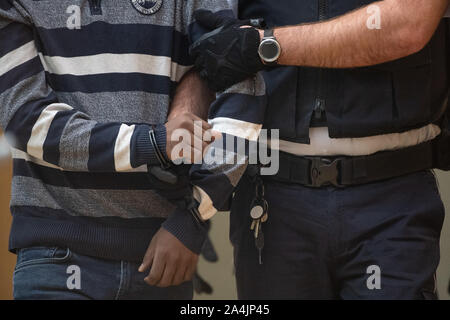 Stuttgart, Germany. 15th Oct, 2019. At the beginning of the trial, the accused is brought before the Stuttgart Higher Regional Court for aiding and abetting the murder. As a member of the rebel group Liberation Tigers of Tamil Eelam (LTTE), the man is said to have been involved in the deadly attack on Sri Lankan Foreign Minister Lakshman Kathirkamar in his home country in 2005. Credit: Sebastian Gollnow/dpa/Alamy Live News Stock Photo