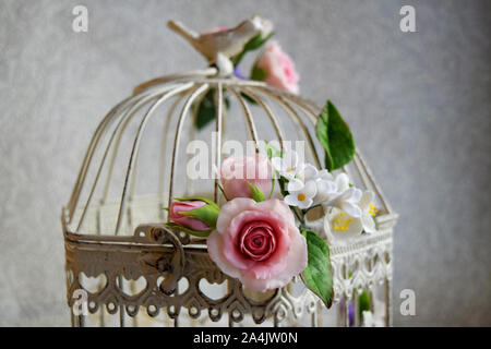 Bird cage with spring blossom flowers. Wedding decorations. Stock Photo