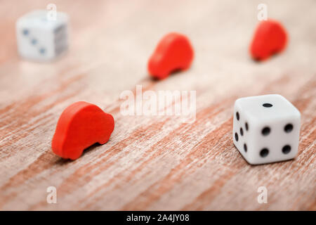 Car insurance background. Insurance policy service concept. Playing dice and wooden red cars on wooden background. Toy cars and playing dice. Conditions and risks of car insurance Stock Photo