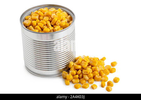 Canned sweet corn in an open metal tin next to spilled sweet corn isolated on white. Stock Photo