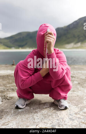 Portrait Of Young Woman At River Covering Face Stock Photo - Alamy
