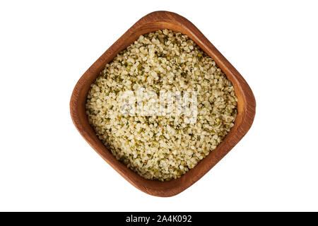 Organic shelled hemp seeds in wooden bowl  isolated on white background Stock Photo
