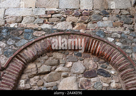 Ancient bricks forming a support arch in an access to an ancient Roman bridge Stock Photo