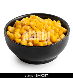 Canned sweet corn in a black ceramic bowl isolated on white. Stock Photo