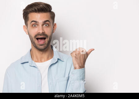 Shocked Caucasian man point at blank copy space Stock Photo