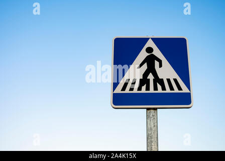 European pedestrian crossing vertical sign with blue, square background and black doll on white background Stock Photo