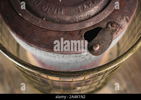 Vertical plane of an old and rusty cast iron stove, with metal grill guard, and open vent opening Stock Photo