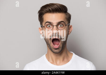 Caucasian man in glasses shocked by unexpected news Stock Photo
