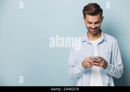 Smiling man using modern smartphone with wireless internet Stock Photo