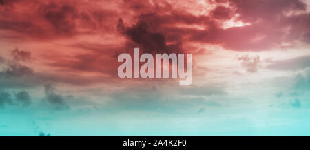 Red blue cloudy sky at sunset, natural background photo with tonal correction filter Stock Photo