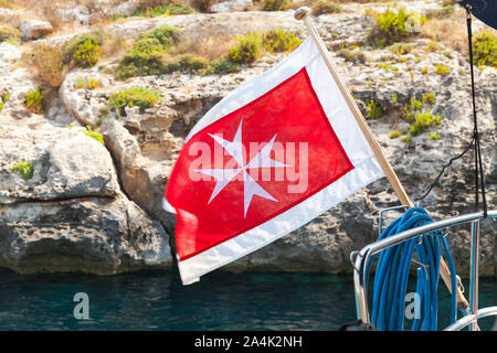 The merchant flag of Malta waving on an yacht stern Stock Photo