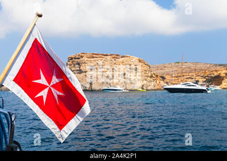 The merchant flag of Malta mounted on an yacht stern Stock Photo