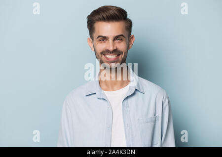 Headshot of smiling caucasian man posing on blue background Stock Photo