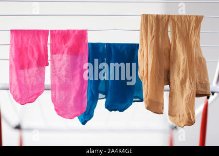 Laundry hanging on drying rack - clothes dryer Stock Photo