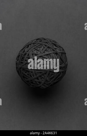 Black rubber band ball isolated on a grey background. 14.10.2019 Please credit: Phillip Roberts Stock Photo