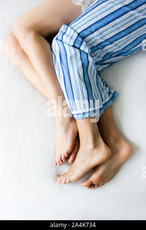 Couple in bed spooning Stock Photo
