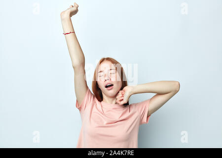 attractive tired woman stretching back, tired and relaxed, sleepy and yawning for early morning, close up portrait, isolated white background, studio Stock Photo