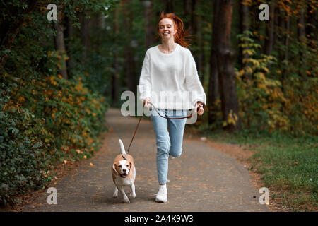 young happy girl in stylish clothes enjoying spending time with her adorable pet, full length photo. happiness, best friend, friendship Stock Photo