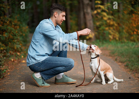 young good looking man training his petto perform some actions, full length side view photo Stock Photo