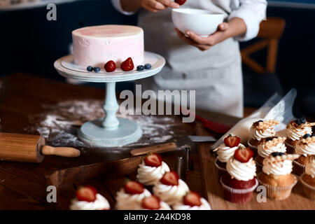 confectioner learning to designing cake, process of cooking confectionary. close up cropped photo Stock Photo