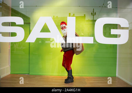 Urban Santa Claus. Walking in city. SALE Stock Photo